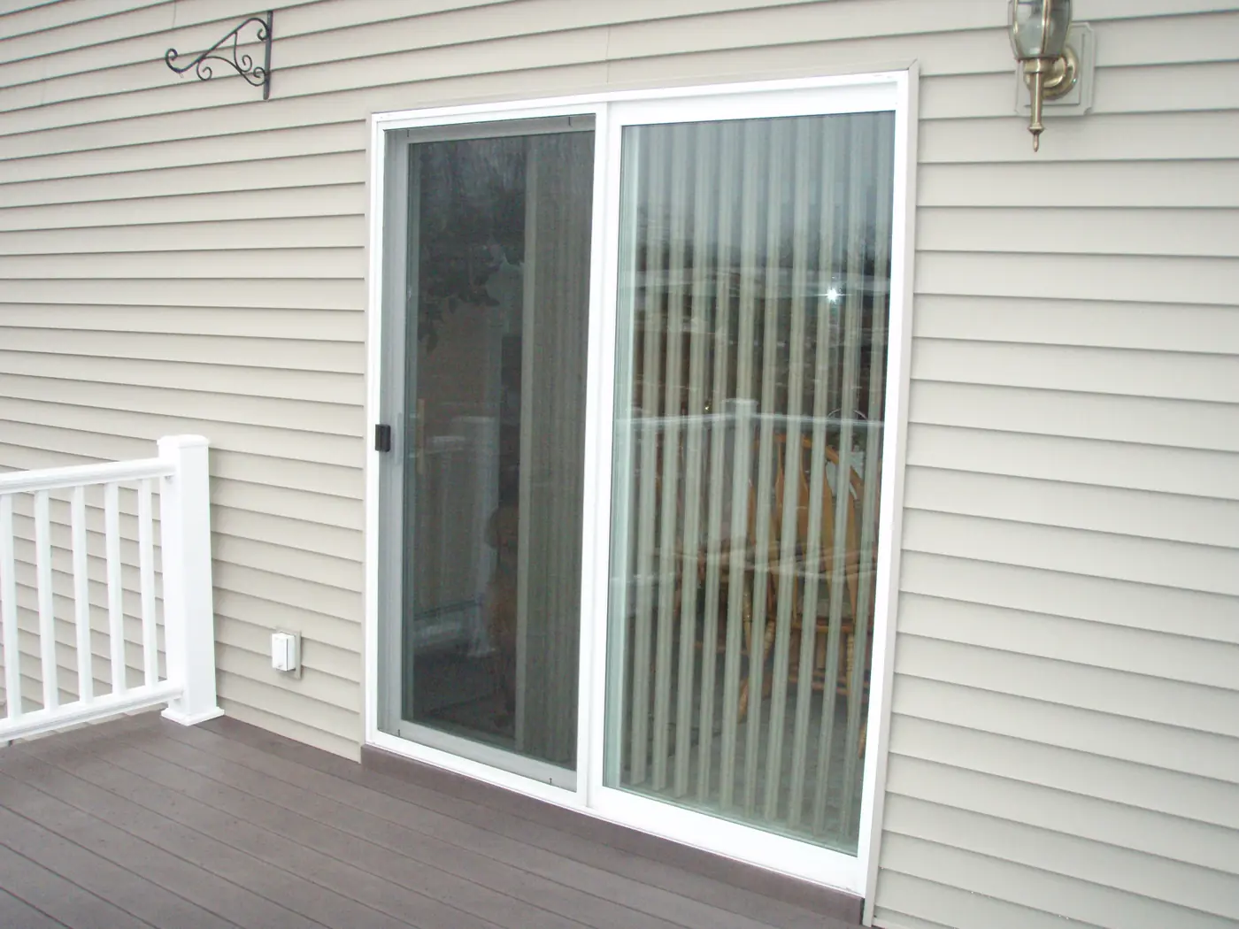 a sliding glass patio door opening onto a wooden deck